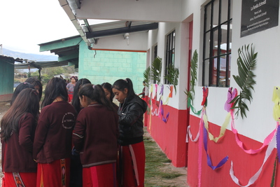 a group of girls circled in front of an expand hope building
