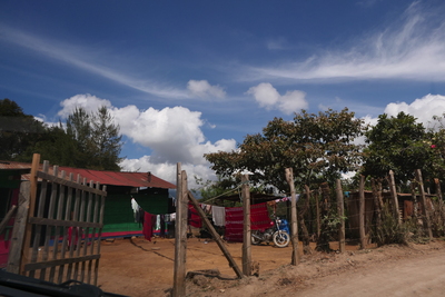 a green house behind a gate in Guatamala