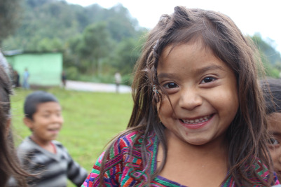 a child smiling into a camera