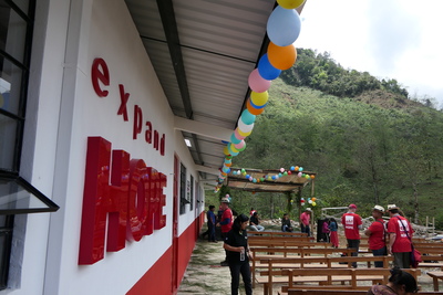 The exterior of the Expand Hope building in Guatemala with colourful balloons lined up along the roof.